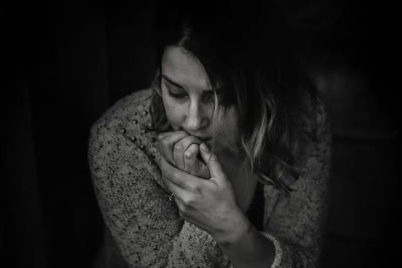 Depressed woman sitting in the dark